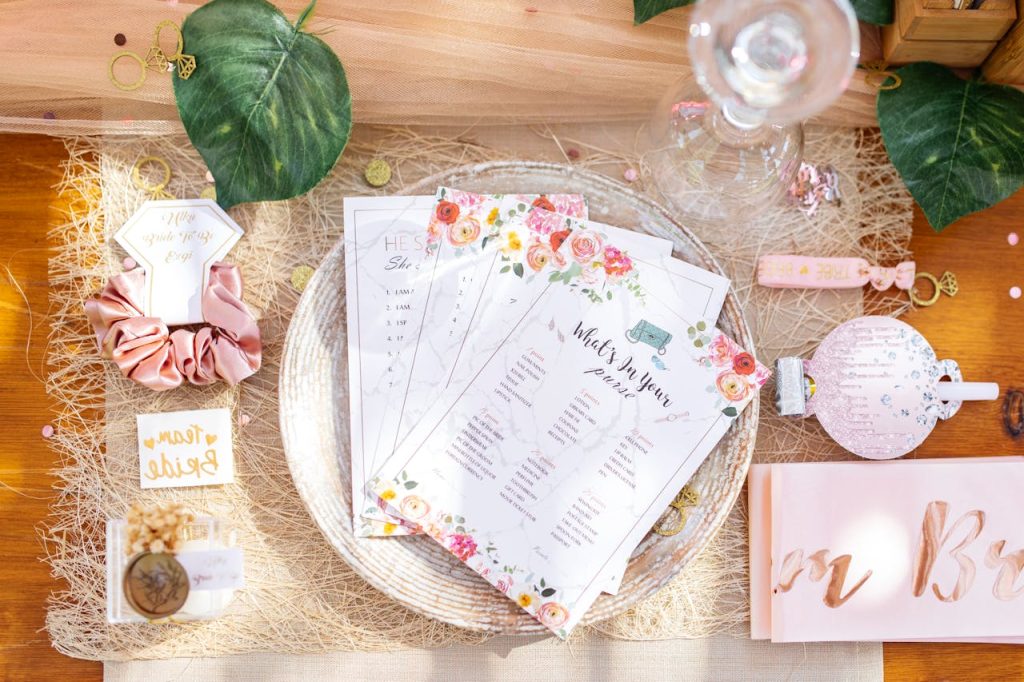 Top view of a bridal shower table setting with floral decor and pink accents, ideal for celebrations.